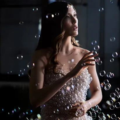 Iris van Herpen made a dress out of 15,000 glass bubbles and it looks like it's literally dissolving